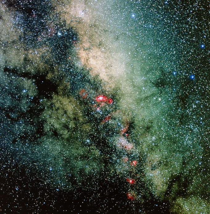 Milky Way. Enhanced optical image of the Milky Way running through the constellation Sagittarius. The Milky Way is our own galaxy; we see it as a band of light crossing the sky. The galactic centre lies in the direction of Sagittarius, so the star clouds are very bright in this region. There are numerous nebulae (pink) visible here. The brightest, at centre, is the Lagoon Nebula (M8). These emission nebulae glow red due to ionisation of their hydrogen gas by radiation from hot young stars embedded within them. This image was produced by a CCD (charge-coupled device), which stores images electronically rather than on film.