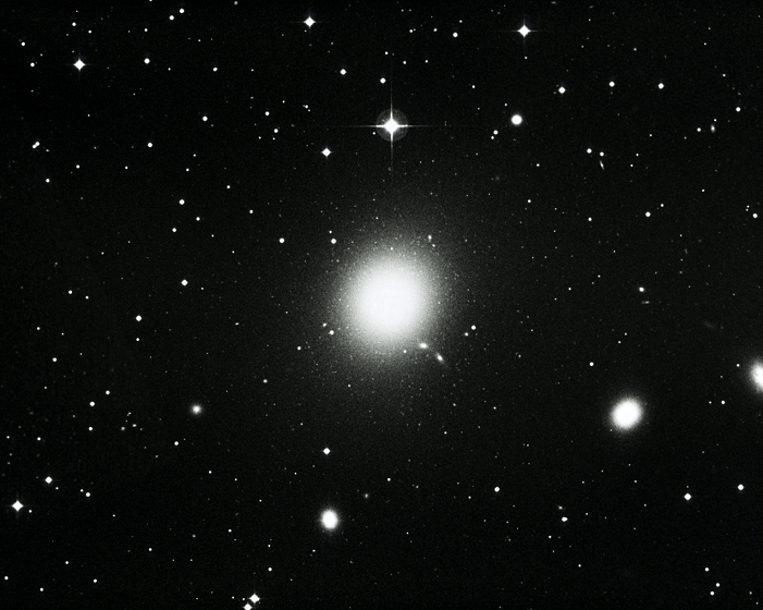 ^BTHIS PICTURE MAY NOT BE USED TO STATE OR IMPLY ^BROE's ENDORSEMENT OF ANY COMPANY OR PRODUCT. *** THIS PICTURE MAY NOT BE USED TO STATE OR IMPLY   ROE ENDORSEMENT OF ANY COMPANY OR PRODUCT *** The giant elliptical galaxy M87 (NGC 4486). M87 is one of the most massive & luminous of all known galaxies. It is surrounded by a halo of about 4000 globular star clusters which are visible here as small fuzzy dots. M87 is also a strong radio source. It is the largest member of the Virgo cluster of galaxies which is the nearest (50 million light years) major cluster to our Local Group. It is formed by 1000 members spread over an area 10 million light years wide. The elliptical galaxy NGC 4478 is just visible at bottom right.