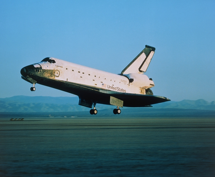 Space Shuttle Columbia landing at the end of the STS-28 mission of 8-13 August 1989. STS-28 was a classified Department of Defense flight. It is believed that the crew deployed an upgraded KH-11 imaging reconnaissance satellite during the mission. On top of the tail fin is the pod of the Shuttle Infrared Leeside Temperature Sensing (SILTS) system. This was used to monitor temperature patterns over the Shuttle's wings and fuselage during deceleration after re-entry. Data from this and later uses of SILTS may help in the design of future re-useable launcher systems. Note also the discolouration of some thermal tiles around the nose, 100 of which had to be replaced.