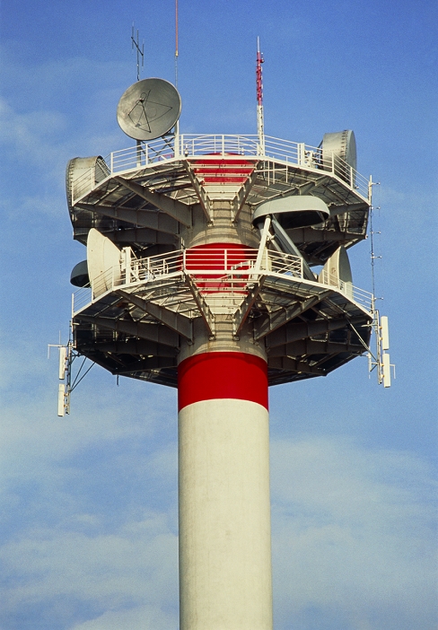 A microwave relay station in France. Towers such as this are employed as links in the French telecommunications network, transmitting and receiving phone, telex and data communications. The drum-shaped aerials use microwave frequencies to beam signals to other similar towers. The towers have to be located so as to ensure an unobstructed path between them.