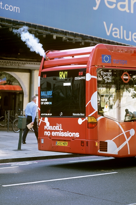 Hydrogen fuel cell bus, London, England. Water vapour is seen venting from an exhaust pipe (upper left). The water vapour forms from the reaction between hydrogen and oxygen in the fuel cell to produce electrical power. This is a cleaner source of power compared to the burning of fossil fuels to form carbon dioxide and other pollutant gases. The bus is part of the CUTE (Clean Urban Transport Europe) project, a demonstration project that is testing 27 hydrogen fuel cell buses, three each in nine European cities. The project started in 2002. London's three buses arrived in November 2003, and began operating in January 2004. The buses are Mercedes-Benz Citaro hydrogen fuel cell buses made by Daimler Chrysler, and are being used on route RV1. Photographed in September 2005.