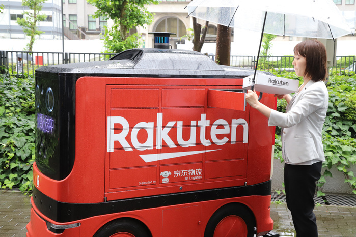 Delivery robots are displayed as public private council is set up to promote last one mile delivery robots June 24, 2019, Tokyo, Japan   Japanese e commerce giant Rakuten employee demonstrates Chinese e commerce company DJ.com s delivery robot are displayed at the entrance of the Ministry of Economy, Trade and Industry  METI  in Tokyo on Monday, June 24, 2019. METI and private companies set up a public private council to promote autonomous delivery robots for the last one mile delivery of parcels.    Photo by Yoshio Tsunoda AFLO 