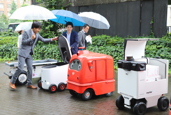 Delivery robots are displayed as public private council is set up to promote last one mile delivery robots June 24, 2019, Tokyo, Japan   Delivery robots  L R  Effidence s EffiBOT of France, Japan s Hakobot, ZMP s CaliRo Deli of Japan and Marble of the United States are displayed at the entrance of the Ministry of Economy, Trade and Industry  METI  in Tokyo on Monday, June 24, 2019. METI and private companies set up a public private council to promote autonomous delivery robots for the last one mile delivery of parcels.    Photo by Yoshio Tsunoda AFLO 