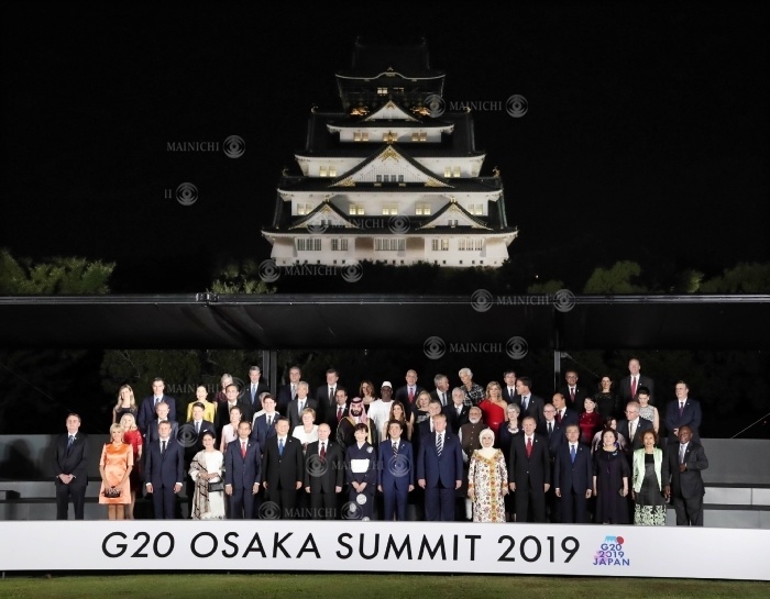 G20 leaders and their spouses pose for a group photo with Osaka Castle in the background. Heads of state and their spouses pose for a group photo with Osaka Castle in the background at 7:43 p.m. on June 28, 2019, in Chuo ku, Osaka.