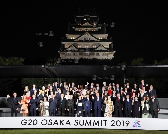 Leaders and their spouses pose for a group photo with Osaka Castle in the background. Heads of state and their spouses pose for a group photo with Osaka Castle in the background in Chuo ku, Osaka, June 28, 2019.