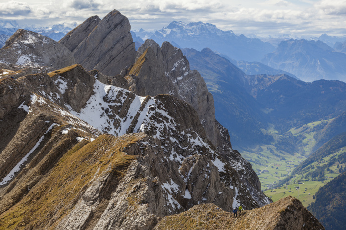 Mountain range in Swiss Alps, Lisengrat, Alpstein, St. Gallen Canton, Switzerland Hikers ascend to a high point off the Lisengrat  Lisen Ridge  trail between Altmann and Santis, Alpstein, canton of St. Gallen, Switzerland.