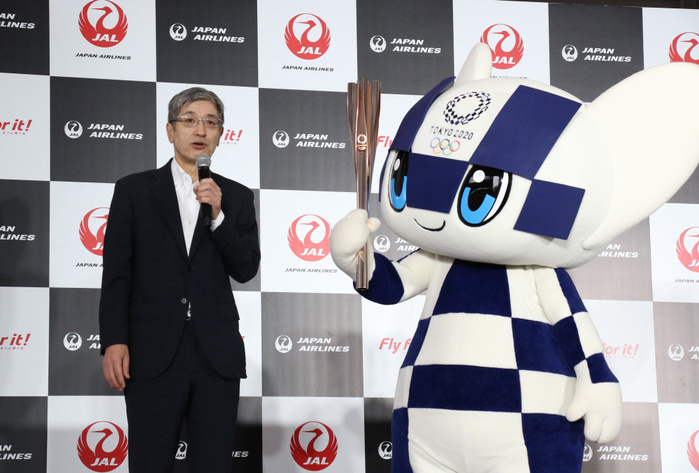 JAL displays the new uniforms for their staffs July 23, 2019, Tokyo, Japan   Japan Airlines  JAL  president Yuji Akasaka speaks while Olympic mascot Miraitowa with Olympic torch looks on at the JAL hangar of the Haneda airport in Tokyo on Tuesday, July 23, 2019. JAL announced they will serve as supporting partner of the Tokyo 2020 Olympic torch relay.     Photo by Yoshio Tsunoda AFLO 