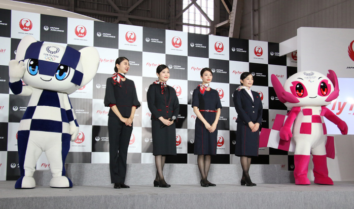 JAL displays the new uniforms for their staffs July 23, 2019, Tokyo, Japan   Japan Airlines  JAL  cabin attendants and ground staffs pose for photo with Olympic mascot Miraitowa  L  and Paralympic mascot Someity  R  as JAL unveils the new uniforms for the flight crews, cabin attendants, ground crews, cargo staffs at the JAL hangar of the Haneda airport in Tokyo on Tuesday, July 23, 2019. JAL announced they will serve as supporting partner of the Tokyo 2020 Olympic torch relay.     Photo by Yoshio Tsunoda AFLO 