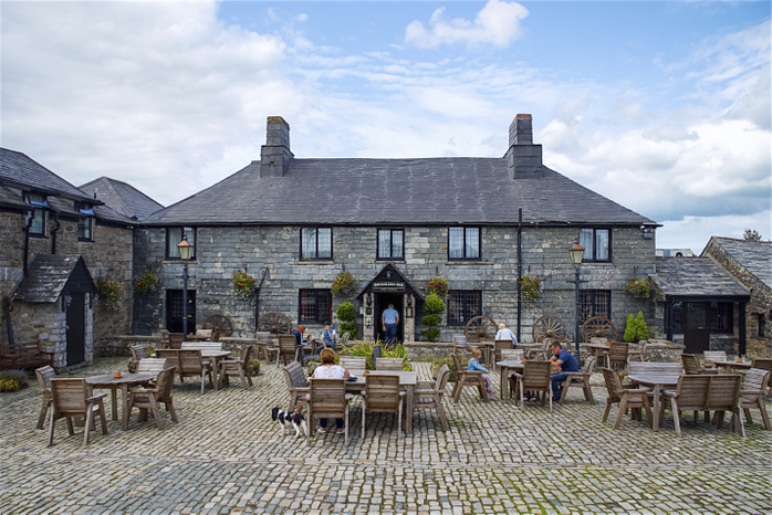 United Kingdom Guests enjoying the outside restaurant patio at Smugglers Bar and Hotel, Jamaica Inn, Bodmin Moor  Launceston, Cornwall, England, Photo by Tania Cagnoni   Design Pics