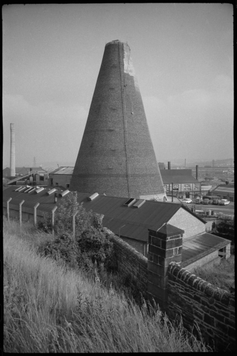 Lemington Glass Cone, Northumberland Road, Lemington, Newcastle upon Tyne, c1955 c1980. Creator: Ursula Clark. Lemington Glass Cone, Northumberland Road, Lemington, Newcastle upon Tyne, c1955 c1980. A general view of the Lemington Cone, a tall brick cone built c1787 for the Northumberland Glass Company, with a scene of industrial buildings and towers in the background. The cone is now part of a factory and has had the upper courses renewed. It has five  segmental arches at the base on the south and west sides, two of which are visible in the image. It is now the only surviving glasshouse on the Tyne.