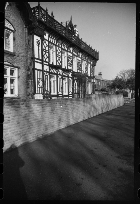 Whitburn House, Front Street, Whitburn, South Tyneside, c1955 c1980. Creator: Ursula Clark. Whitburn House, Front Street, Whitburn, South Tyneside, c1955 c1980. An exterior view of the front elevation of Whitburn House, a stone and half timber house, seen from the south. The house dates from 1867 1869, and was built for Thomas Barnes, a coal owner. The first two bays are gabled and of stone, with three light windows on the ground floor, and two light windows with segmental pediments on the first floor. The next five bays of the house are timber framed, with a central door and timber porch. Under the first, second and fifth first floor windows are balconies supported by eaves, mirrorer by the timber eaves supporting the jettied balcony with timber parapet. Behind the balcony are three gabled dormer windows with timber surround. The main entrance of the house is to the rear.