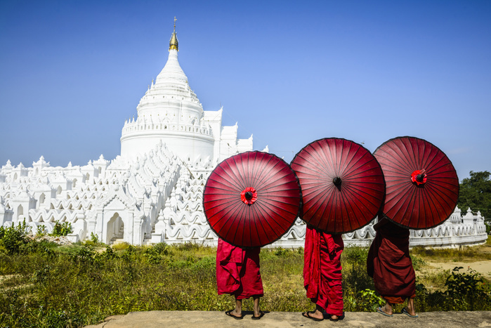 Asian monks under umbrellas viewing historic temple, Mingun, Mandala, Myanmar,Mingun, Mandalay, Myanmar Asian monks under umbrellas viewing historic temple, Mingun, Mandala, Myanmar