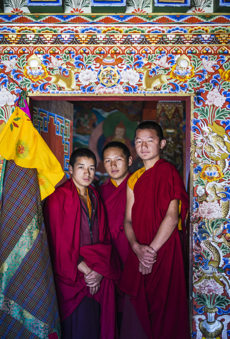 Asian monks standing in temple doorway,Bhutan, Bhutan, Kingdom of Bhutan Asian monks standing in temple doorway