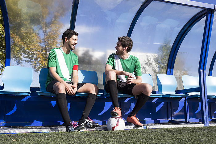 Campo de Futbol 1  Jose Futbol  Oscar Futbol Two happy football players sitting on bench at football field talking