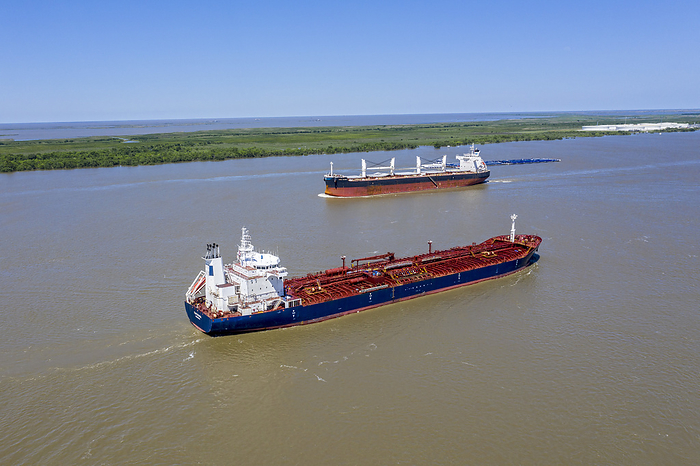 Ships on Mississippi River, USA Ships on Mississippi River. Liberian oil chemical tanker Tintomara  foreground  travelling along the Mississippi River, USA, towards the Gulf of Mexico, while the Greek bulk carrier Doric Victory heads towards New Orleans. Photographed in Empire, Louisiana, USA.