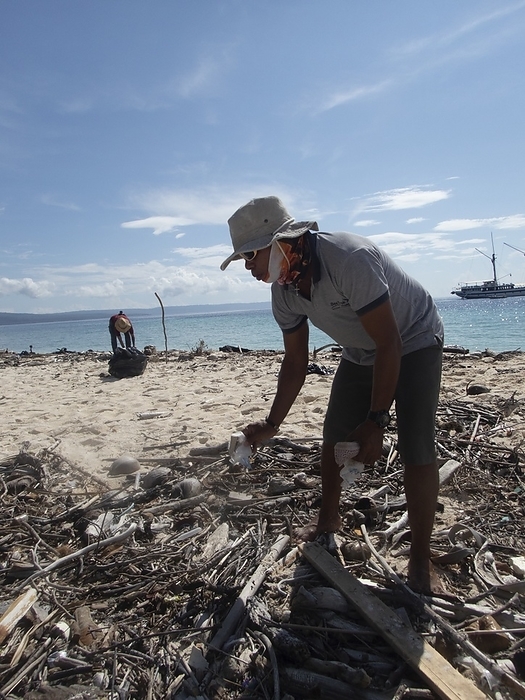 Collecting plastic waste, Indonesia Collecting plastic waste. The crew of an eco friendly cruise ship collecting plastic waste on a beach in Indonesia.