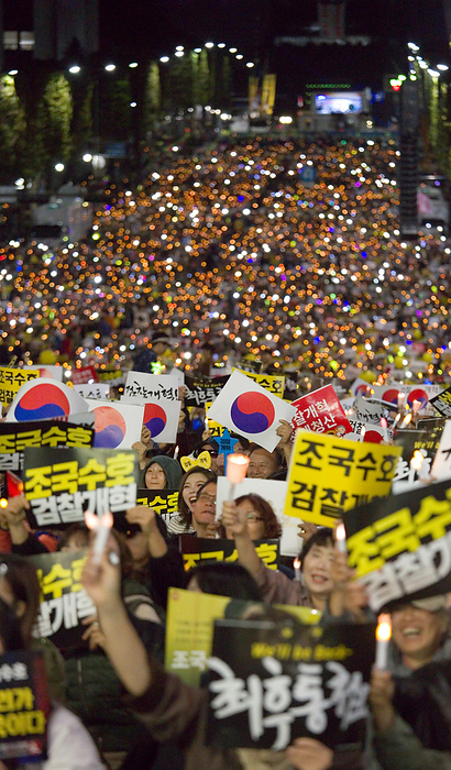 People attend a rally demanding prosecution reform near the Supreme Public Prosecutors  Office in Seoul Protest demanding prosecution reform, October 12, 2019 : South Koreans attend a rally demanding prosecution reform near the Supreme Public Prosecutors  Office in Seoul, South Korea. Tens of thousands of people held a peaceful street candlelight vigil to support Justice Minister Cho Kuk and to denounce Prosecutor General Yoon Seok Youl. Prosecutors have been investigating into allegations against Cho s family which were mostly raised by opposition parties and some news outlets. People at the rally vowed to defend Cho and President Moon Jae In, arguing that the influential prosecution is attempting to force minister Cho to quit in protest against prosecution reform. People accused the prosecution of abusing its authority and deliberately leaking information related to the ongoing probe to the media ahead of any trial. Moon s former aide Cho is an architect of the liberal government s prosecution reform scheme including creating an independent unit to investigate corruption by high ranking government officials and granting police more authority. Signs read, Defending Cho Kuk  and  Prosecution Reform .  Photo by Lee Jae Won AFLO   SOUTH KOREA 