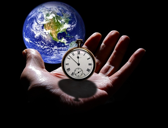 Earth with hand and stopwatch Earth with hand and stopwatch. Composite image illustrating the idea that time is running out for Earth.