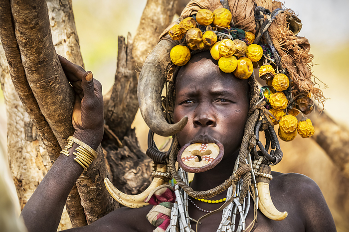 Mursi woman wearing a lip plate in a village in Mago National Park; Omo Valley, Ethiopia, Photo by Peter Langer