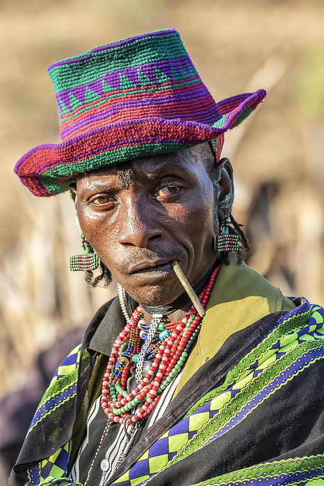 Hamer man wearing a colourful hat at a bull jumping ceremony, which initiates a boy into manhood, in the village of Asile, Omo Valley, Ethiopia, Photo by Peter Langer