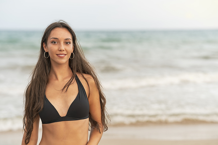 Portrait of beautiful young woman in bikini on the beach Portrait of beautiful young woman in bikini on the beach