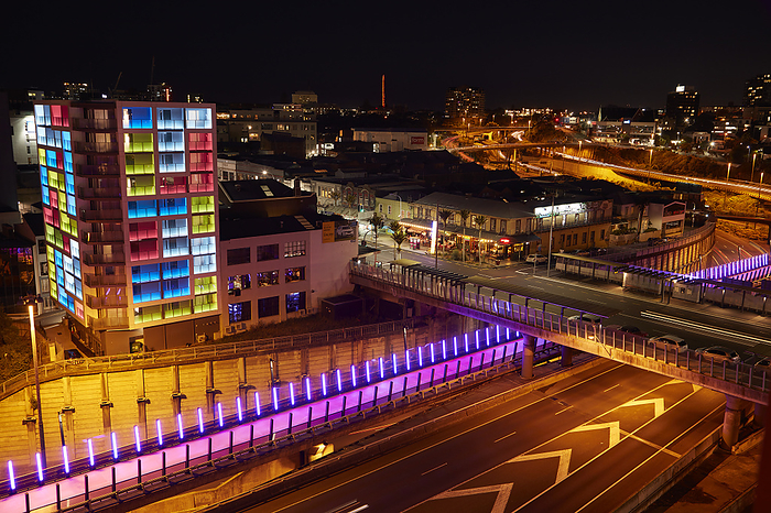New Zealand Colourful apartment building, motorway, Lightpath cycleway, and Carmen Jones Eatery, Karangahape Rd, Auckland, North Island, New Zealand