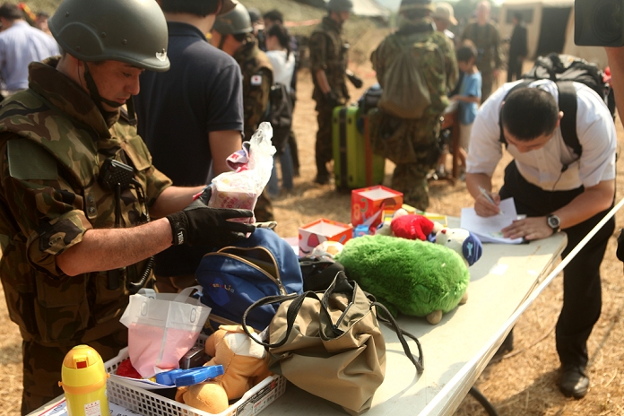 Land Self Defense Force Conducts Evacuation Exercise in Thailand Participation in Multilateral Joint Drill A service member with the Japanese Air Force searches the contents of a Japanese citizen s bags during a non combatant evacuation Royal Thai military, the Japanese Self Defense Force and the 31st Marine Expeditionary Unit participated in the NEO, conducted Cobra Gold 2011 ensures the region is adequately prepared for humanitarian disasters, such as the December 2004 Indian Ocean tsunami and Cyclone Nargis. Cobra Gold 2011 ensures the region is adequately prepared for humanitarian disasters, such as the December 2004 Indian Ocean tsunami and Cyclone Nargis in May 2008.