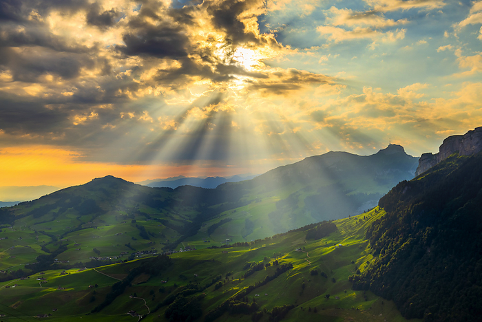 Switzerland Sun rays filters between clouds at sunrise, Canton of Appenzell, Alpstein, Switzerland, Europe, Photo by Francesco Bergamaschi