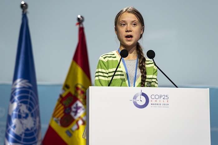 Greta Thunberg addressing COP25, Madrid, Spain, 2019 Editorial use only   Swedish climate activist Greta Thunberg  born 2003  giving a speech at the 2019 United Nations Climate Change Conference, known as COP25. Thunberg rose to prominence at the age of 15 when she campaigned for action on global warming, with her protests leading to a worldwide movement of school strikes for action on climate change. She has continued to campaign on these issues and the needed lifestyle changes to avert a climate catastrophe. Photographed in Madrid, Spain, on 11th December 2019.