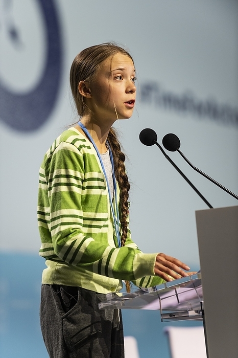 Greta Thunberg addressing COP25, Madrid, Spain, 2019 Editorial use only   Swedish climate activist Greta Thunberg  born 2003  giving a speech at the 2019 United Nations Climate Change Conference, known as COP25. Thunberg rose to prominence at the age of 15 when she campaigned for action on global warming, with her protests leading to a worldwide movement of school strikes for action on climate change. She has continued to campaign on these issues and the needed lifestyle changes to avert a climate catastrophe. Photographed in Madrid, Spain, on 11th December 2019.