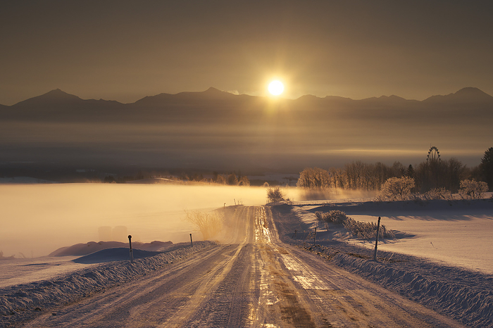 Sunrise, morning fog and road in the Tokachi Mountain Range, Hokkaido, Japan  17 C