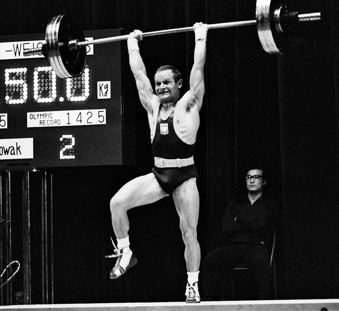 1964 Tokyo Olympics Weightlifting, Men s Featherweight Mr. Novak  Poland  lifted 150 kg in the featherweight jerk. He raised one leg to show his strength.