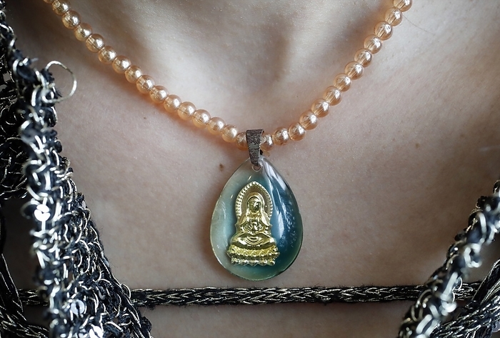 Buddhist woman with a Buddha pendant.  Vung Tau. Vietnam. 