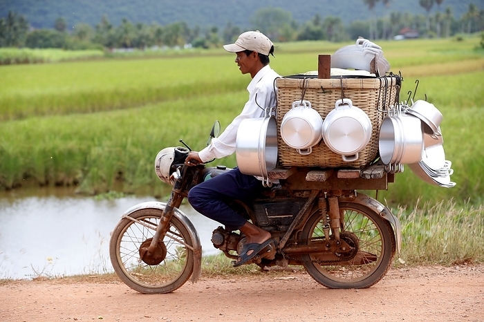 Motorcycle carrying produce to be sold in the countryside.  Kep. Cambodia. 