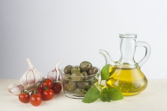 Olive oil, basil, garlic and tomato Olive oil, basil, garlic and tomato. Conceptual image of Mediterranean diet.