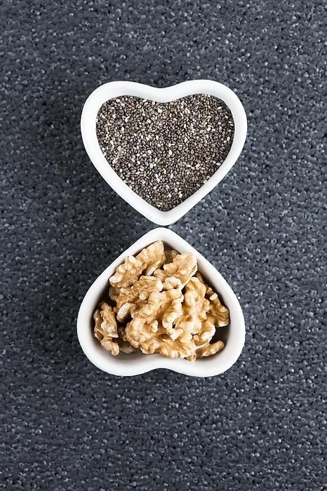 Black chia seeds and walnuts in heart shaped dish Black chia seeds and walnuts in heart shaped dish. Chia seeds  Salvia hispanica  and walnuts  Juglans sp.  are high in omega 3 which are good for a healthy heart.