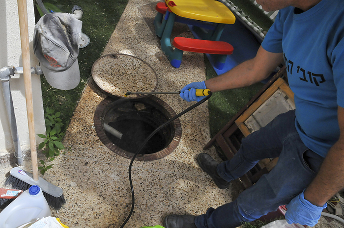 Pest control Pest control. Fumigating a sewer manhole.