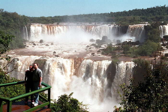 Iguazu Falls, Brazil  2000   Let s go on a trip  Brazil: A Country of Vast Natural and Cultural Heritage, and the World s Three Greatest Waterfalls: Iguazu Falls  Some foreign tourists are in a good mood at the observatory with the majestic Iguazu Falls in the background. 