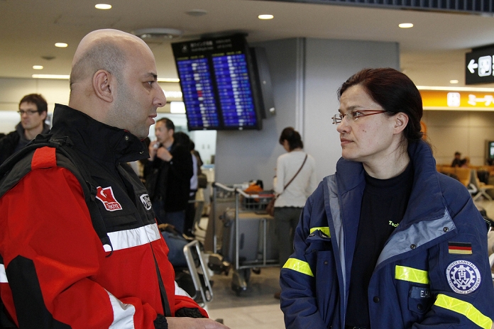 Great East Japan Earthquake Rescue teams from various countries arrive in Japan  March 13, 2011, Narita, Japan   German rescue team staff, right, chats with Turkey team staff, left, at Narita International Airport in Narita, Chiba Prefecture on on Sunday, March 13, 2011. The international community started to send disaster relief teams to help Japan after it suffered a biggest earthquake struck the Tohoku region coast on Friday.   Photo by AFLO   0006   ty 