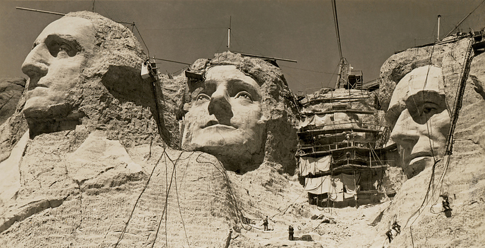 Mt. Rushmore, South Dakota:  c. 1938.
Workmen on the faces of Mount Rushmore.  Roosevelt has the scaffolding over his face.