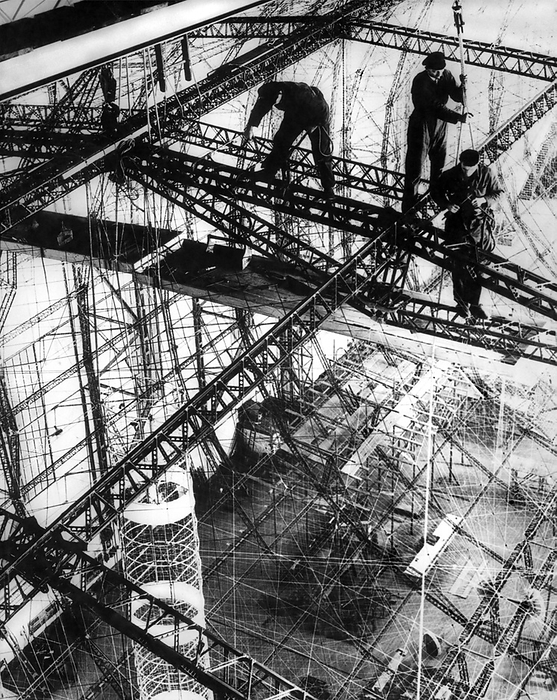Friedrichshafen, Germany:  c. 1933.
The frame of the LZ 129 is taking shape at the Zeppelin Works in Friedrichshafen. It was soon to be named after the late Paul von HIndenburg, the President of Germany, who died in 1934. The frame was made of Duralumin, one of the earliest aluminum alloys, and  the skin was of to be of cotton that was doped with a mixture of aluminum and iron oxide to protect it against ultraviolet and infrared light. Unfortunately, this mixture reacted violently when it was heated, resulting in extremely high temperatures.