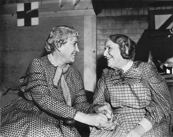 United States:  c. 1930
Two happy senior women hold hands and smile at each other.