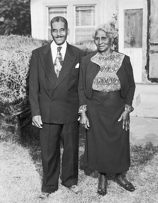 United States:  c. 1938
An older African American man and his wife pose for a portrait outside their home.