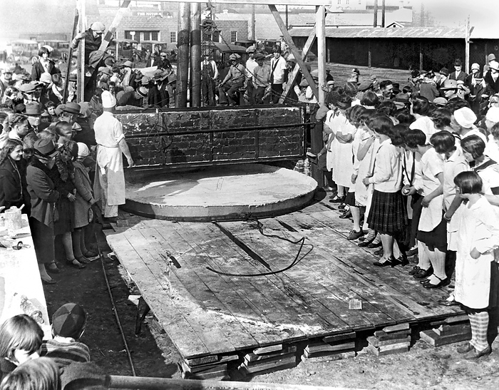 Yakima, Washington:   October, 1927.
Bakers preparing to bake  the world's largest apple pie to celebrate National Apple Week in Yakima. The pie is 10 feet across, has 400 gallons of apples, and it took five cords of wood to heat the oven to bake it. It weighs 1 ton, and was consumed by 2000 school children.