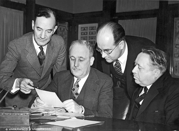Washington, DC:  January 29, 1936.
Bureau of Engraving officials confer on the design of the new 