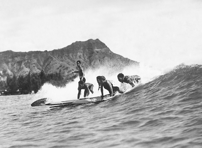 Honoluly, Hawaii:  c. 1925
Native Hawaiians riding their surfboards at Waikiki Beach with Diamond Head in the background.