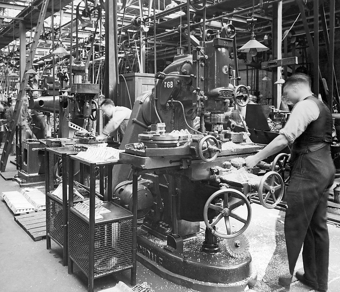 London, England: c. 1936
Workers at Handley Page's Cricklewood works are engaged in the government expansion mandate to triple the size of the Royal Air Force by March 31, 1937. Here are workers in the milling section of the main machine shop.