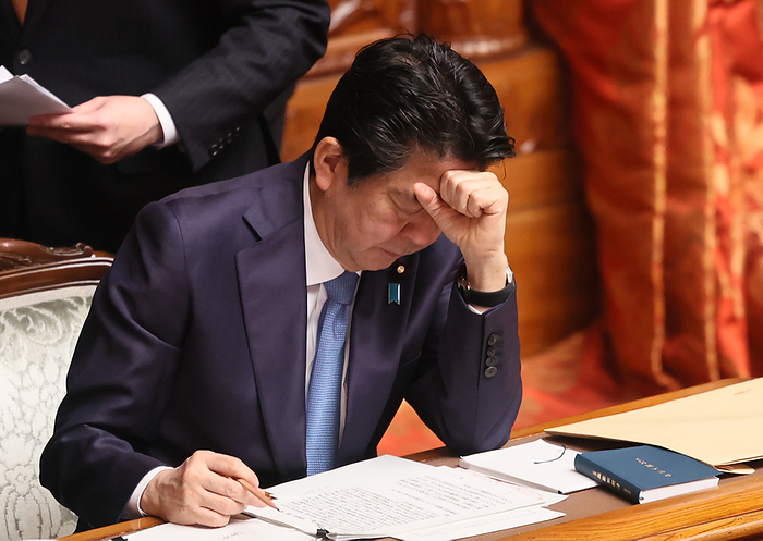 Japanese Prime Minister Shinzo Abe attends Upper House s plenary session March 6, 2020, Tokyo, Japan   Japanese Prime Minister Shinzo Abe checks his manuscript as he answers a question by an opposition lawmaker at Upper House s plenary session at the National Diet in Tokyo on Friday, March 6, 2020. Japanese government will announce another package to tackle against coronavirus COVID 19 next week.     Photo by Yoshio Tsunoda AFLO 