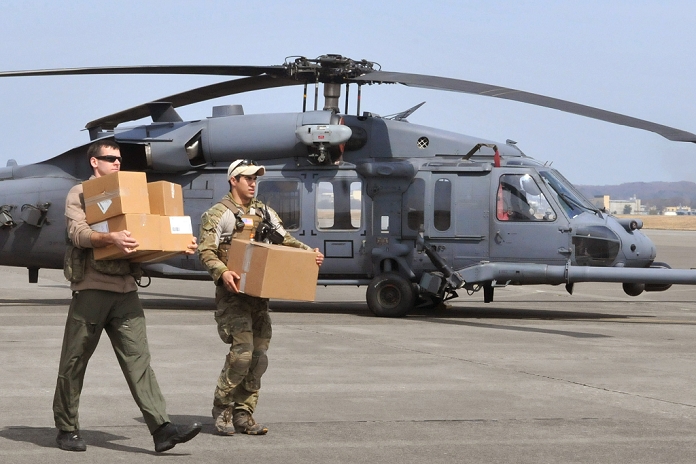 Great East Japan Earthquake Operation Friends Two Airmen carry medical supplies to an HH 60G Pave Hawk prior to take off March 20, 2011, at Yokota Air Base, Japan. Airmen from the 33rd Rescue Squadron successfully transported supplies to displaced peoples in Kessenuma City, in support of Operation Tomodachi. Kessenuma experienced massive destruction from the earthquake and tsunami in northeastern Japan, March 11.  Photo by USAF AFLO   0006 