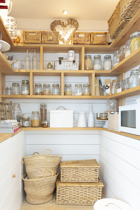 Woven baskets and food jars in pantry